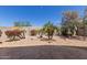 Landscaped backyard featuring a stone patio, desert plants, and clear blue skies at 9032 W Sierra Pinta Dr, Peoria, AZ 85382