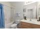 Bright bathroom with white cabinets, tile floors, and combined tub and shower at 9032 W Sierra Pinta Dr, Peoria, AZ 85382