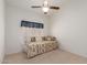Cozy bedroom featuring neutral carpet, bright natural light, and ceiling fan at 9032 W Sierra Pinta Dr, Peoria, AZ 85382