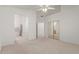 Bright bedroom with carpet flooring and open access to a bathroom and mirrored closet at 9032 W Sierra Pinta Dr, Peoria, AZ 85382