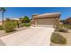 Home featuring a stone facade, two-car garage, and driveway at 9032 W Sierra Pinta Dr, Peoria, AZ 85382