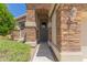 View of the front entryway featuring stone archway, light fixtures, and desert landscaping at 9032 W Sierra Pinta Dr, Peoria, AZ 85382