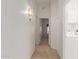 Neutral hallway with recessed lights leading to the bedrooms and the laundry room at 9032 W Sierra Pinta Dr, Peoria, AZ 85382