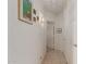 Hallway featuring tile flooring, white walls, and decorative wall decor at 9032 W Sierra Pinta Dr, Peoria, AZ 85382