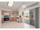 Bright kitchen featuring tile floors, wooden cabinets, and a sliding glass door to the patio at 9032 W Sierra Pinta Dr, Peoria, AZ 85382