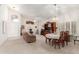 Living room with neutral walls, carpet, a front door, and dining area at 9032 W Sierra Pinta Dr, Peoria, AZ 85382