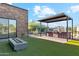 This backyard features a built-in outdoor kitchen, fire pit, and artificial turf at 915 W Ardmore Rd # 11, Phoenix, AZ 85041