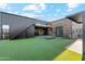 Lush backyard features green lawn, outdoor firepit, covered patio, and modern home architecture at 915 W Ardmore Rd # 11, Phoenix, AZ 85041