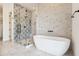 Elegant bathroom featuring a standalone tub, glass shower, and stylish tile work throughout at 915 W Ardmore Rd # 11, Phoenix, AZ 85041
