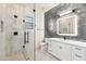 Modern bathroom features glass shower, vanity with sleek hardware, and stylish tile accent wall at 915 W Ardmore Rd # 11, Phoenix, AZ 85041
