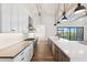 Modern kitchen featuring a large island with a sink, stainless steel appliances, and a seamless connection to the outdoors at 915 W Ardmore Rd # 11, Phoenix, AZ 85041