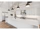 Well-lit kitchen boasts a large white island, modern appliances, and ample counter space for culinary enthusiasts at 915 W Ardmore Rd # 11, Phoenix, AZ 85041