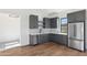 Beautiful kitchen with stainless steel refrigerator and grey cabinets at 915 W Ardmore Rd # 11, Phoenix, AZ 85041