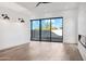 Bright living room featuring a modern fireplace and expansive sliding doors leading to the outdoor area at 915 W Ardmore Rd # 11, Phoenix, AZ 85041