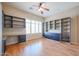 Bedroom featuring wood floors, window shutters, and custom shelving at 9698 S 183Rd Ave, Goodyear, AZ 85338