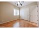 Neutral bedroom featuring a ceiling fan, wood floors, window shutters, and closet at 9698 S 183Rd Ave, Goodyear, AZ 85338