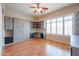 Bedroom featuring a Murphy bed, wood floors, window shutters, and custom shelving at 9698 S 183Rd Ave, Goodyear, AZ 85338