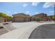 Expansive driveway leads to this single-story home with a three-car garage at 9698 S 183Rd Ave, Goodyear, AZ 85338