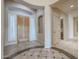 Stunning foyer with intricate tile flooring and a beautiful wooden front door at 9698 S 183Rd Ave, Goodyear, AZ 85338