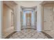 Spacious foyer with decorative tile and view of the front door and shuttered sidelights at 9698 S 183Rd Ave, Goodyear, AZ 85338