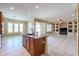 Open concept kitchen, adjoining to the Gathering room, features a granite island with dark wood cabinets at 9698 S 183Rd Ave, Goodyear, AZ 85338