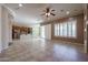 Open-concept living space with tile floors connecting the living room to the kitchen at 9698 S 183Rd Ave, Goodyear, AZ 85338