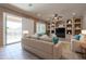 Comfortable living room featuring neutral furniture, built-in shelving, and direct access to outdoor pool at 9698 S 183Rd Ave, Goodyear, AZ 85338