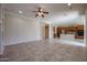 Open-concept layout shows the living room and kitchen featuring tile flooring and recessed lighting at 9698 S 183Rd Ave, Goodyear, AZ 85338