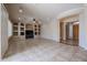Bright living room with recessed lighting, built-in shelving, and a tile floor at 9698 S 183Rd Ave, Goodyear, AZ 85338