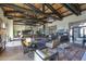 Spacious gathering area has beamed ceilings, stylish decor, and comfortable seating at 9698 S 183Rd Ave, Goodyear, AZ 85338