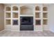 Living room showing built-in shelving, a TV and cabinet, and earth tone paint at 9698 S 183Rd Ave, Goodyear, AZ 85338