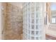 Main bathroom shows a glass block walk-in shower and a wall mounted towel rack at 9698 S 183Rd Ave, Goodyear, AZ 85338