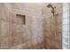 Walk-in shower in main bathroom with tiled walls and shower head and built-in shower niche at 9698 S 183Rd Ave, Goodyear, AZ 85338