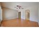 Expansive main bedroom features hardwood flooring, ceiling fan, and doors to bathroom and walk-in closet at 9698 S 183Rd Ave, Goodyear, AZ 85338