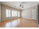 Bright main bedroom boasts three large windows with shutters and wood flooring at 9698 S 183Rd Ave, Goodyear, AZ 85338