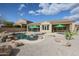 Lush backyard oasis featuring a unique pool design complemented by native desert vegetation, creating a tranquil retreat at 9698 S 183Rd Ave, Goodyear, AZ 85338