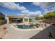 Inviting backyard pool area featuring desert landscaping and shade umbrellas for a relaxing outdoor experience at 9698 S 183Rd Ave, Goodyear, AZ 85338
