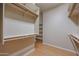 Spacious walk-in closet features a custom closet system and rod for clothing at 9698 S 183Rd Ave, Goodyear, AZ 85338