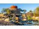 Community water feature with stone tower and waterfall, creating a serene and visually appealing focal point at 9698 S 183Rd Ave, Goodyear, AZ 85338
