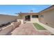Private backyard brick paved patio area with block wall, flowerbeds, and green space at 10713 W Santa Fe Dr, Sun City, AZ 85351