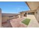 Private backyard brick paved patio area with block wall, flowerbeds, and green space at 10713 W Santa Fe Dr, Sun City, AZ 85351