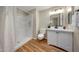 Updated bathroom featuring new vanity, toilet and tiled shower with neutral colors at 10713 W Santa Fe Dr, Sun City, AZ 85351