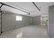 Spacious two car garage with neutral painted walls and high ceilings for storage at 10713 W Santa Fe Dr, Sun City, AZ 85351
