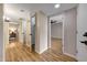 Spacious hallway with wood-like floors and doors leading to various rooms in the home at 10713 W Santa Fe Dr, Sun City, AZ 85351