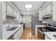 Open kitchen with white cabinetry, stainless steel appliances, and stylish backsplash, perfect for cooking at 10713 W Santa Fe Dr, Sun City, AZ 85351