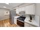 Updated kitchen with stainless steel appliances, white cabinets, and sleek countertops for a modern look at 10713 W Santa Fe Dr, Sun City, AZ 85351
