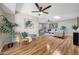 Hardwood floors, ceiling fan, and stylish decor are highlighted in this comfortable living space at 10713 W Santa Fe Dr, Sun City, AZ 85351