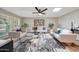 Spacious living room with hardwood floors, stylish rug, neutral palette and lots of natural light at 10713 W Santa Fe Dr, Sun City, AZ 85351