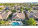 Aerial view of a home with a private backyard featuring a pool, spa, and shaded patio at 10846 E Quartet Ave, Mesa, AZ 85212
