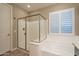 Bathroom featuring shower, tub and natural light at 10846 E Quartet Ave, Mesa, AZ 85212
